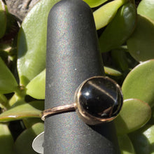 Load image into Gallery viewer, Black star diopside ring, angled view showing the gold filled bezel and band