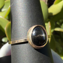 Load image into Gallery viewer, Black star diopside ring, angled view showing the gold filled bezel and band