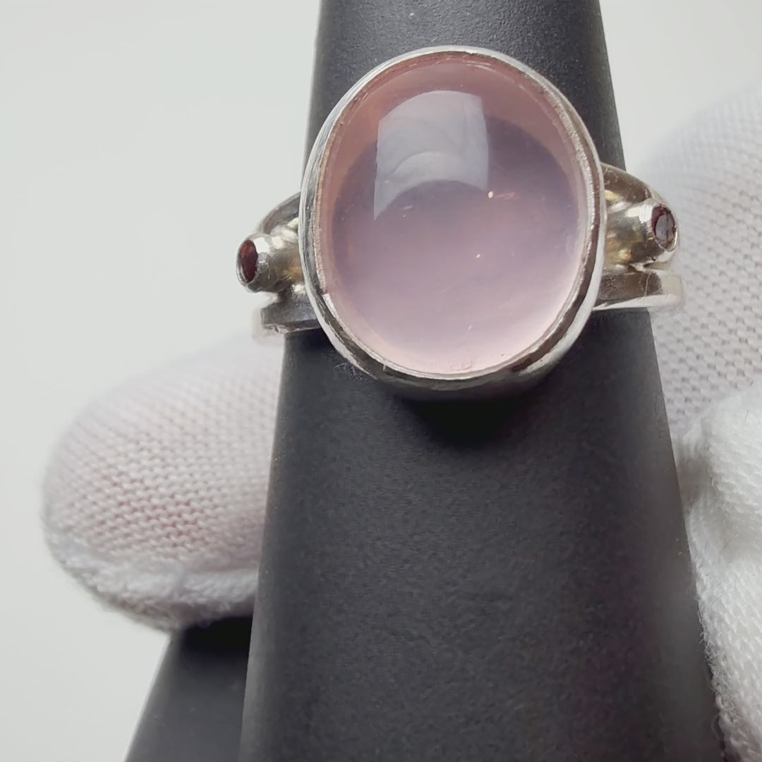 Rose Quartz with Amethyst Accents ring turning on a ring display