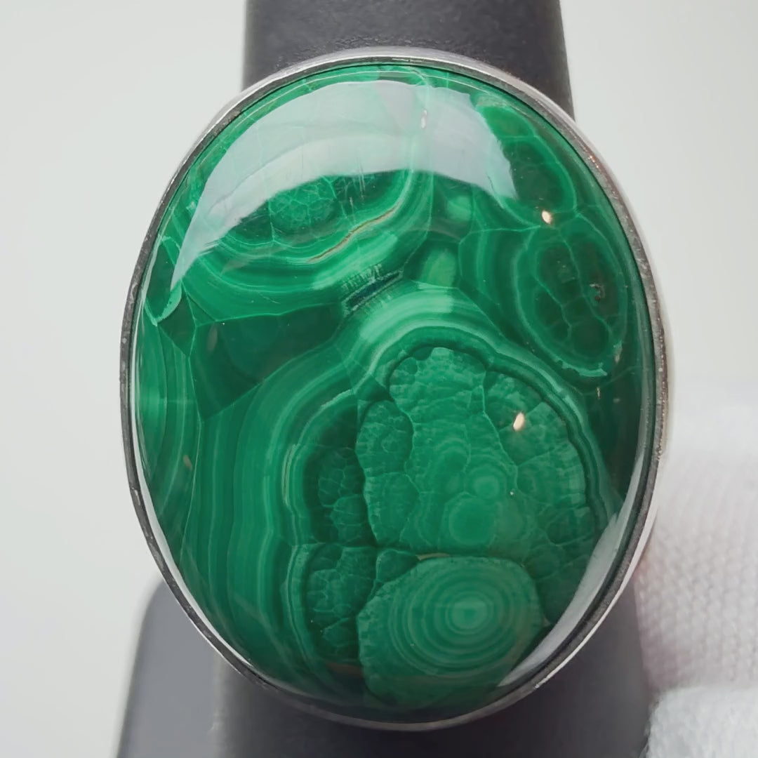 Oval Malachite ring turning on a ring display