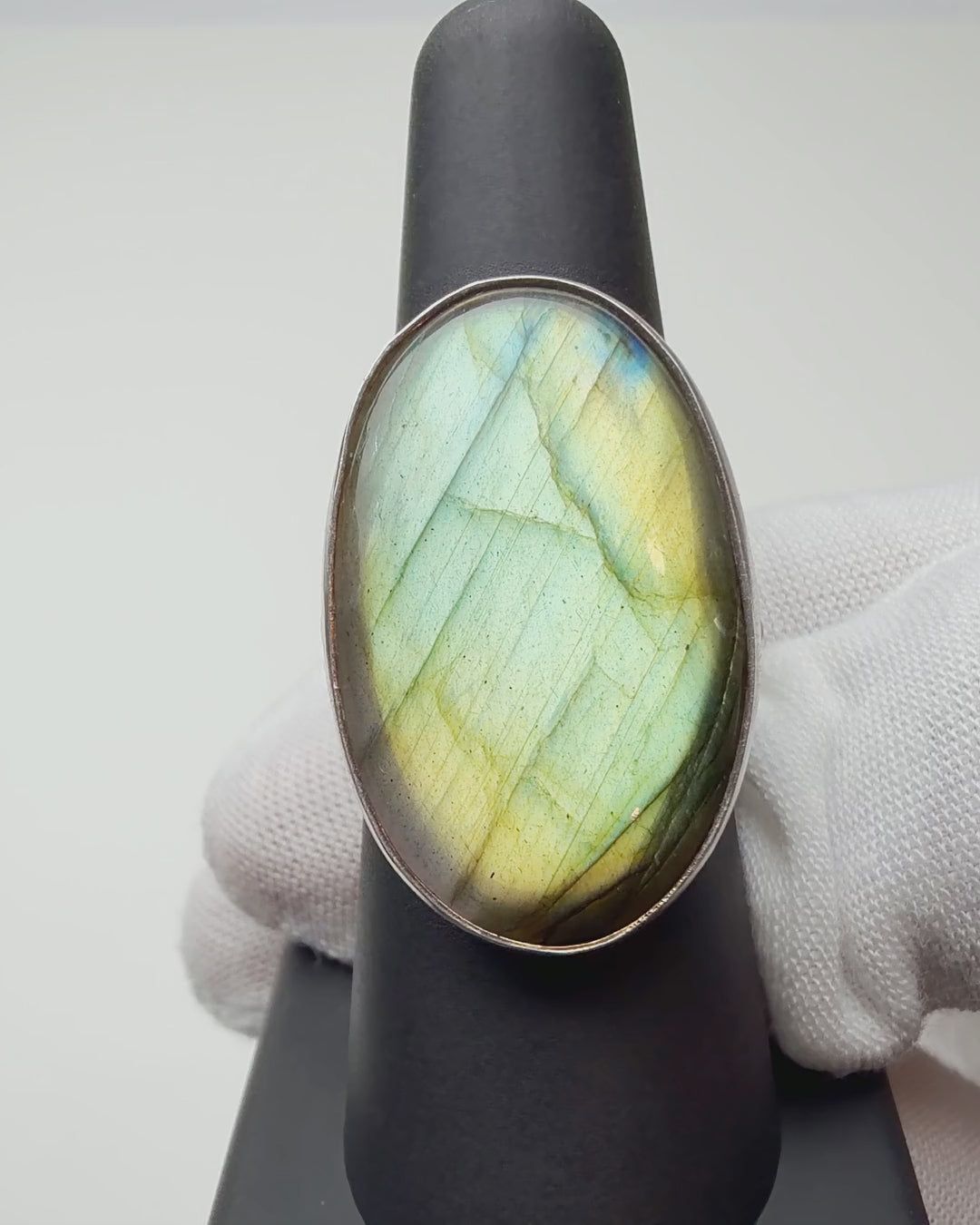 Green Oval Labradorite ring turning on a ring display
