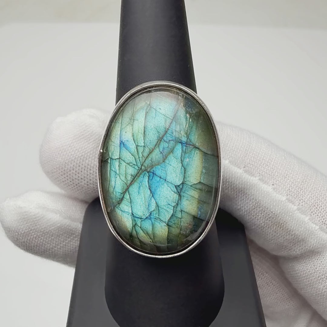 Oval labradorite ring turning on a ring display