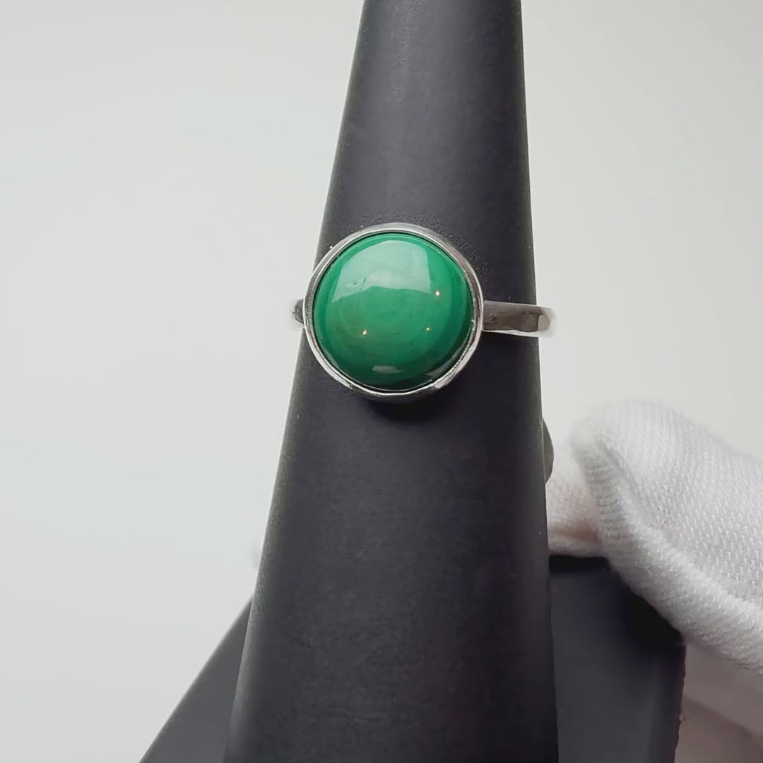Round Malachite ring turning on a ring display